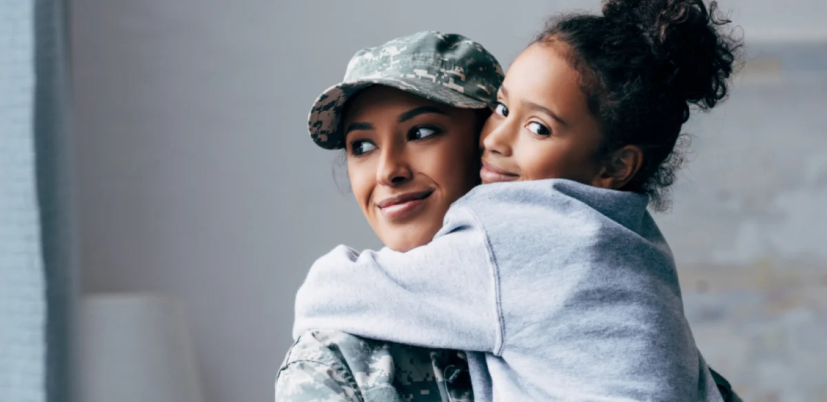 Military motherhugging her daughter